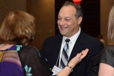 Andy Hyman, talks with other attendees at Community Catalyst's anniversary dinner. 